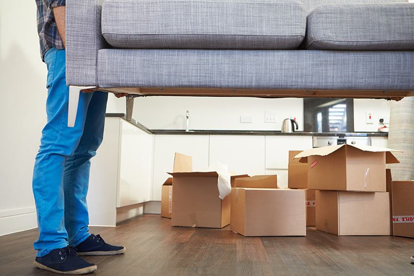 man lifting couch