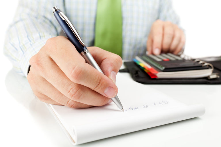 close up of businessman writing math on paper