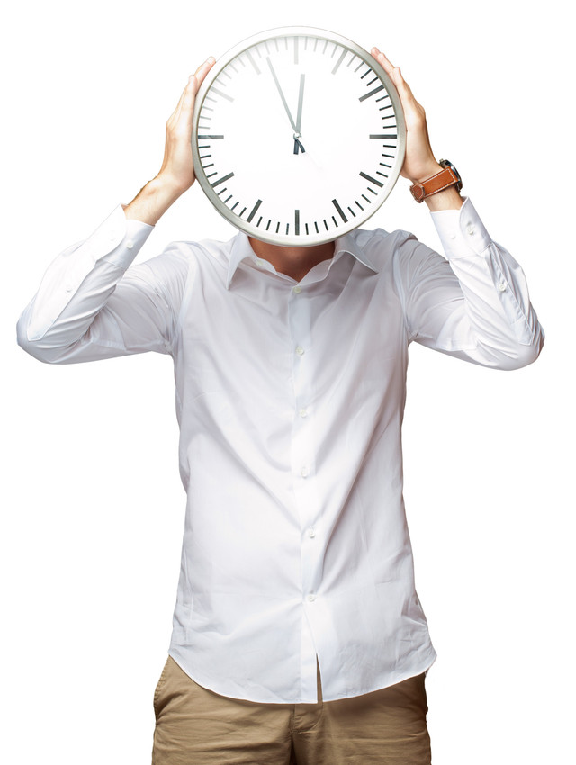 guy holding a clock in front of his face