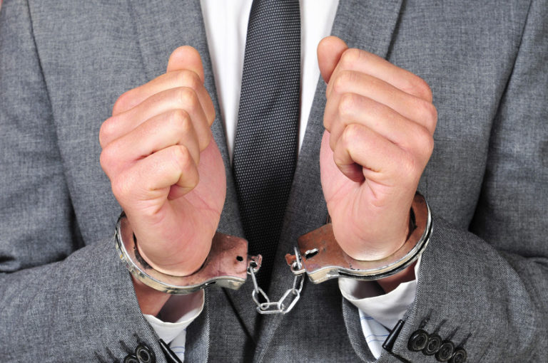 businessman in handcuffs close up